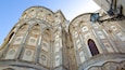 Un edificio storico con decorazioni in maioliche elaborate e finestre ad arco.