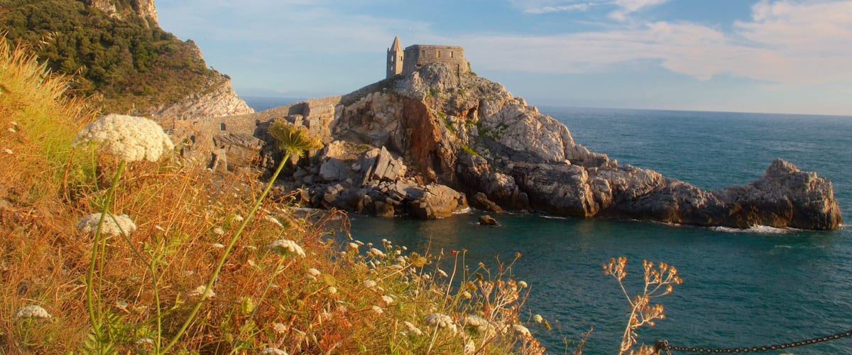 Church of St. Peter which includes general coastal views and rocky coastline