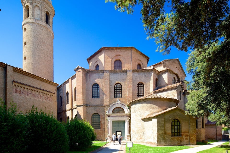 A historic church with a tall bell tower and arched windows.