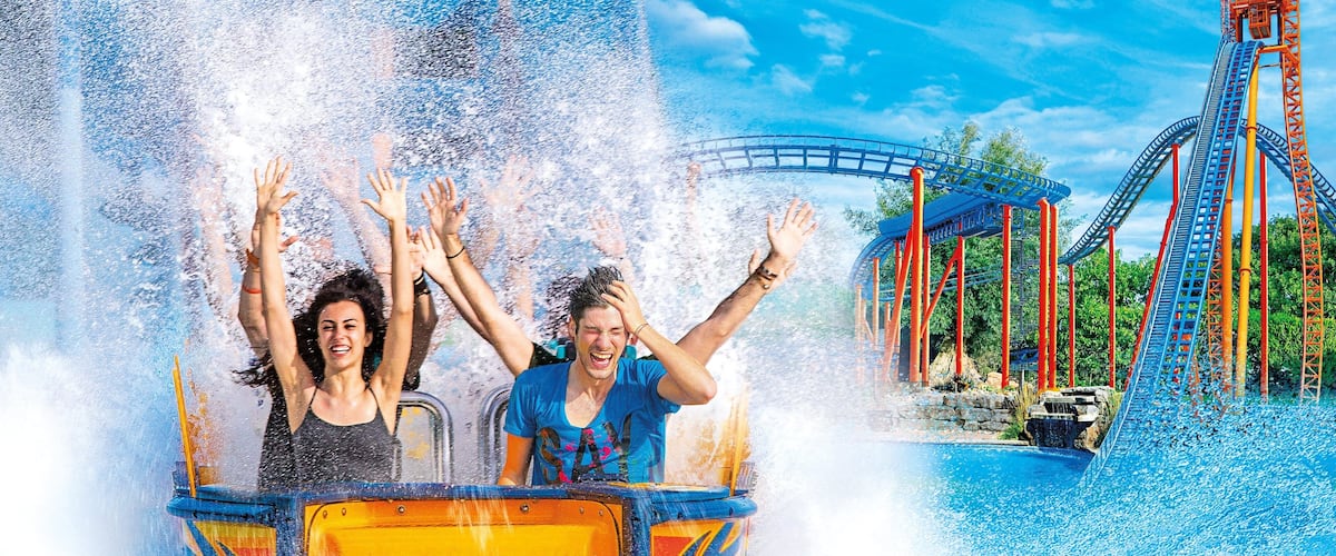Mirabilandia showing rides and a waterpark as well as a small group of people