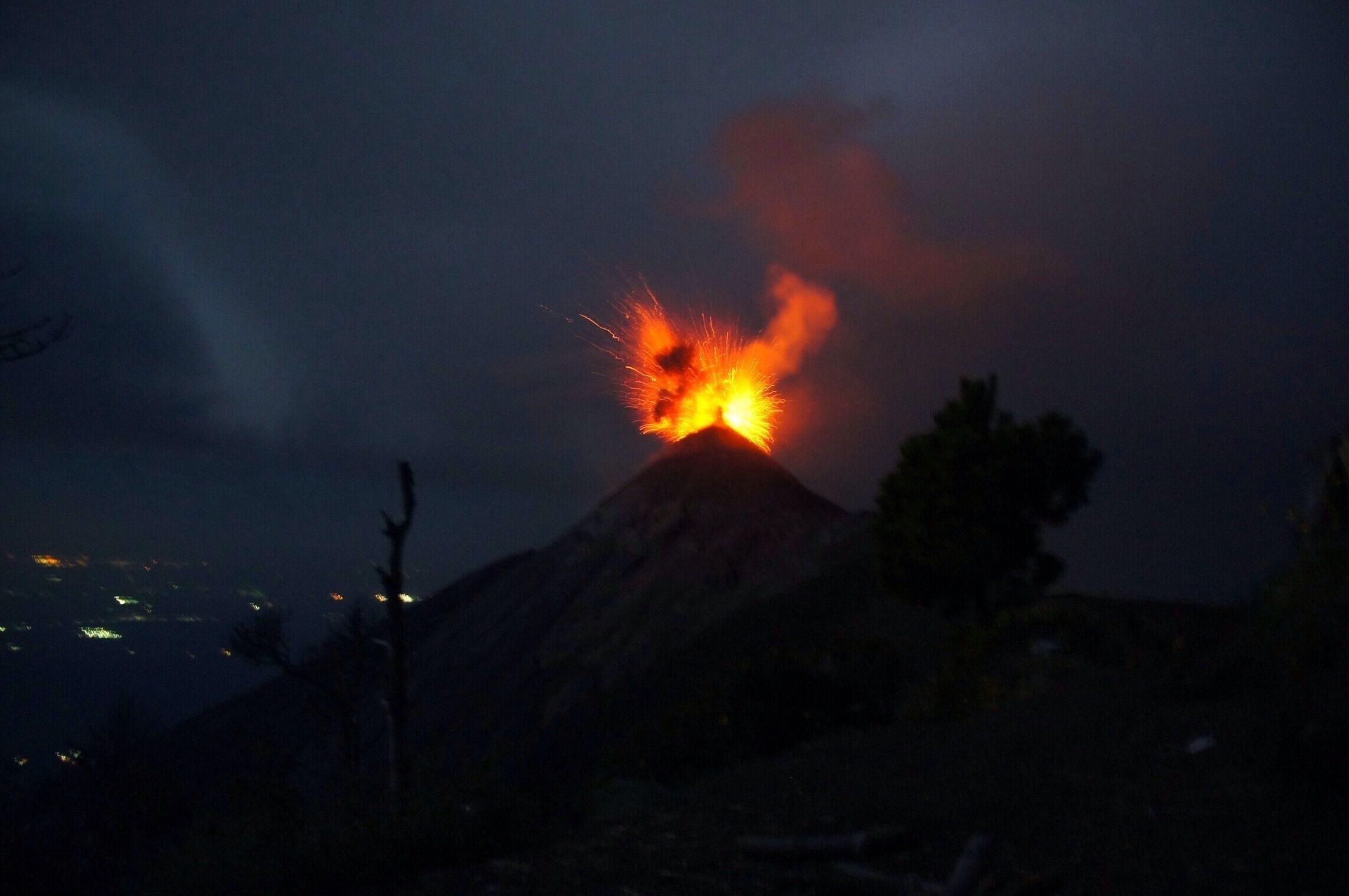 We were the only people on Volcán Acatenango camping the night. The moon was shining right above us, while flashes of lightning were striking below at cloud level. The fog cleared up and we could feel the ground rumbling. All of a sudden, a red plume appears and Volcán Fuego is spewing lava like there's no tomorrow.