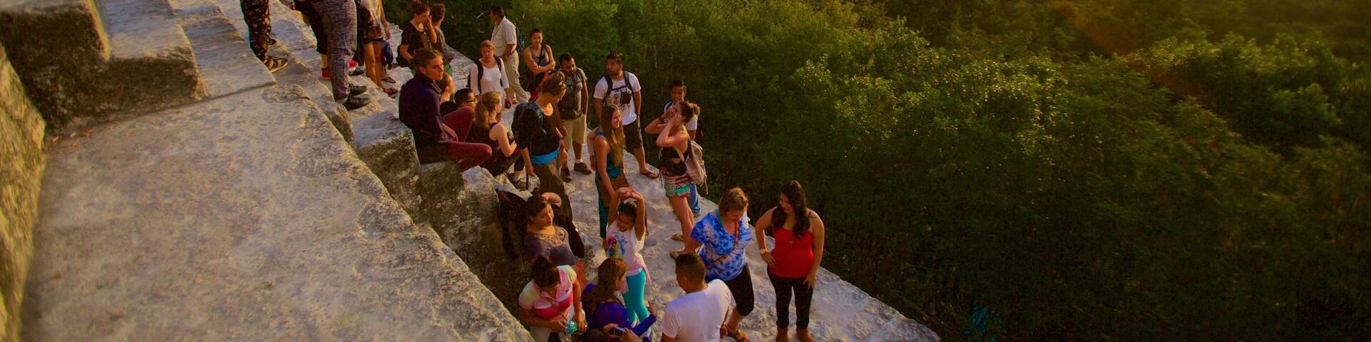 Tikal which includes a sunset, forest scenes and tranquil scenes