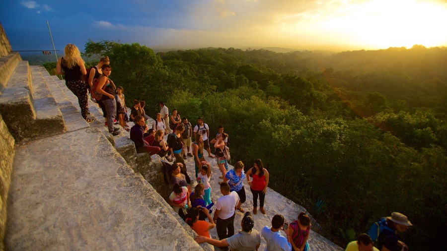 Tikal which includes a sunset, forest scenes and tranquil scenes