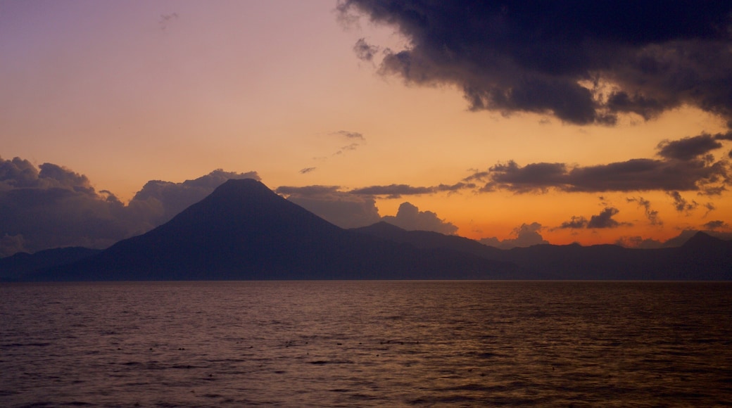 Atitlan Volcano which includes general coastal views, mountains and a sunset