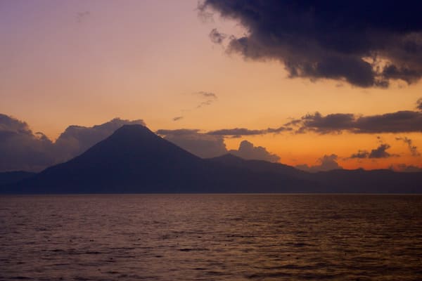 Atitlan Volcano which includes general coastal views, mountains and a sunset