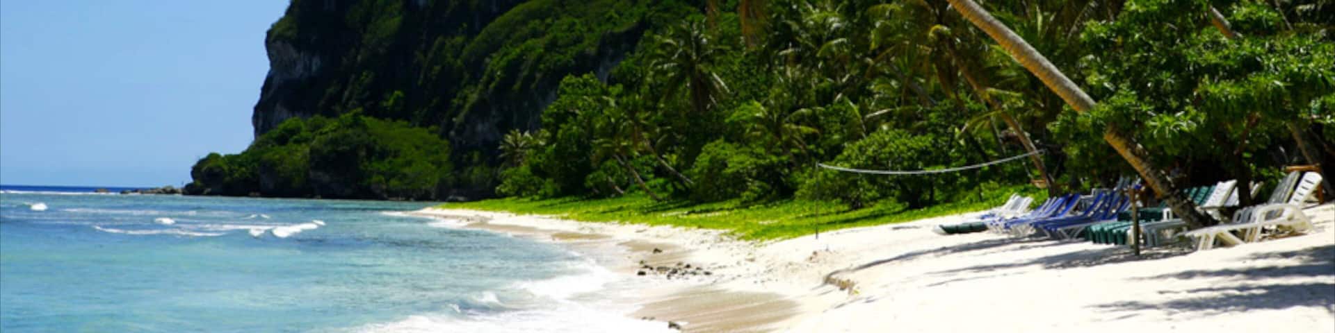 Tumon Beach showing a gorge or canyon, tropical scenes and a sandy beach