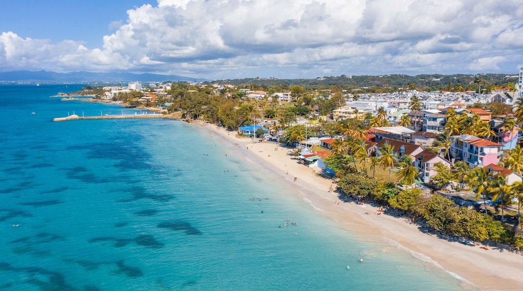 Scenic aerial view of La Datcha beach (Le Gosier plage) in Guadeloupe. Beautiful summer sunny look of small paradise tropical island in Caribbean sea. Several boats and yachts in blue sea.