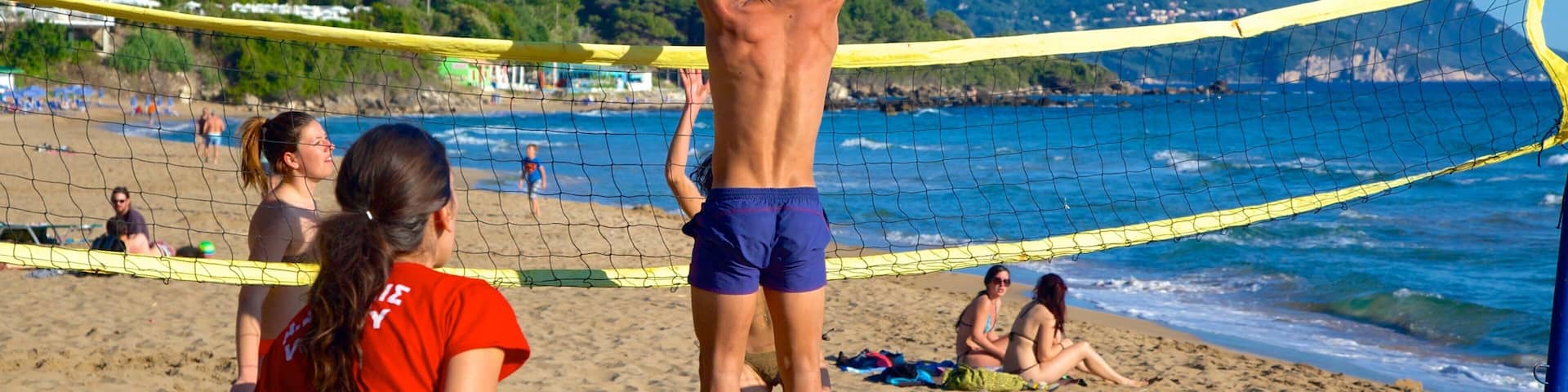 Pelekas Beach which includes a beach and a coastal town as well as a small group of people