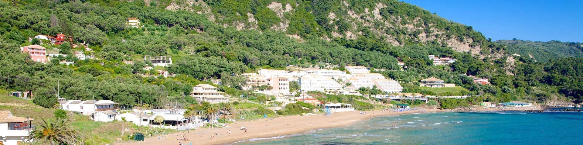 Pelekas Beach showing a coastal town, landscape views and a beach
