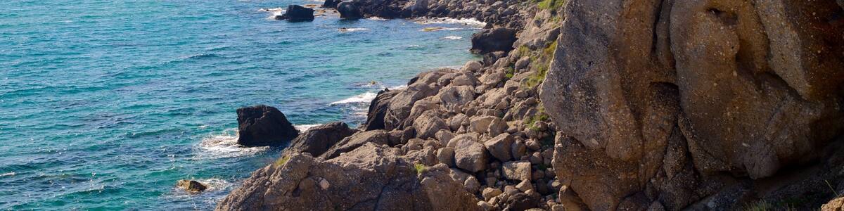 Pelekas Beach showing rocky coastline and landscape views
