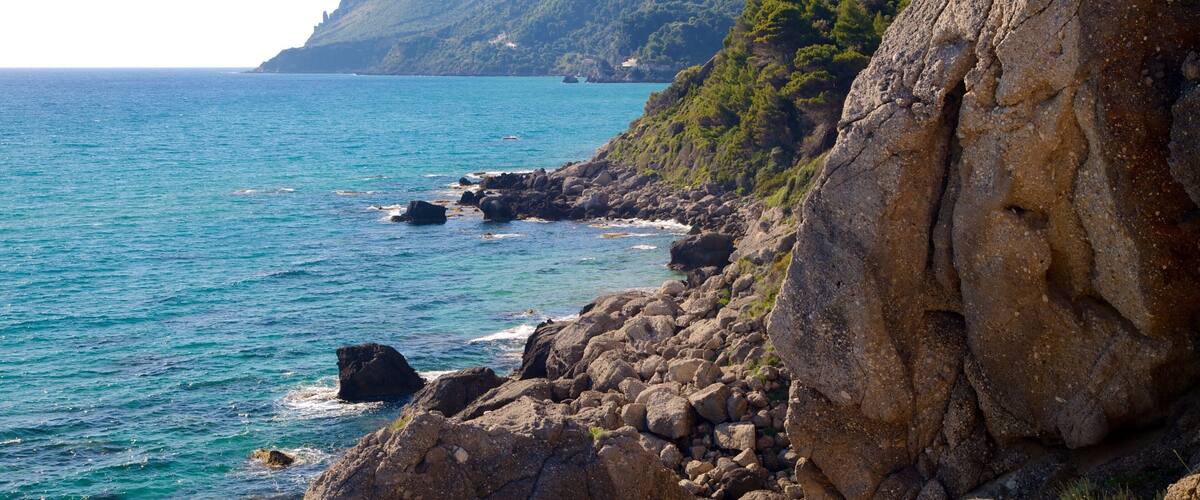 Pelekas Beach showing rocky coastline and landscape views