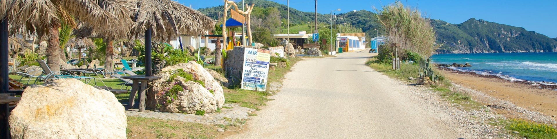 Arillas Beach featuring a coastal town and landscape views