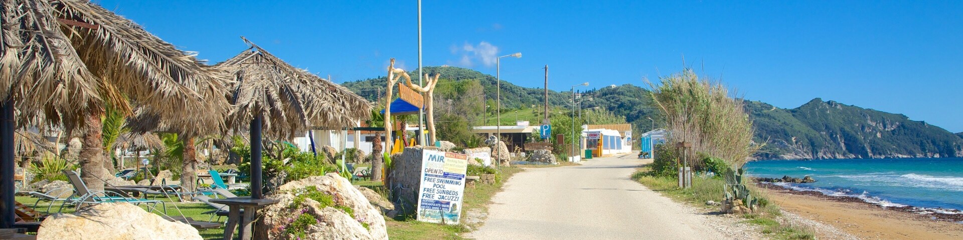 Arillas Beach featuring a coastal town and landscape views