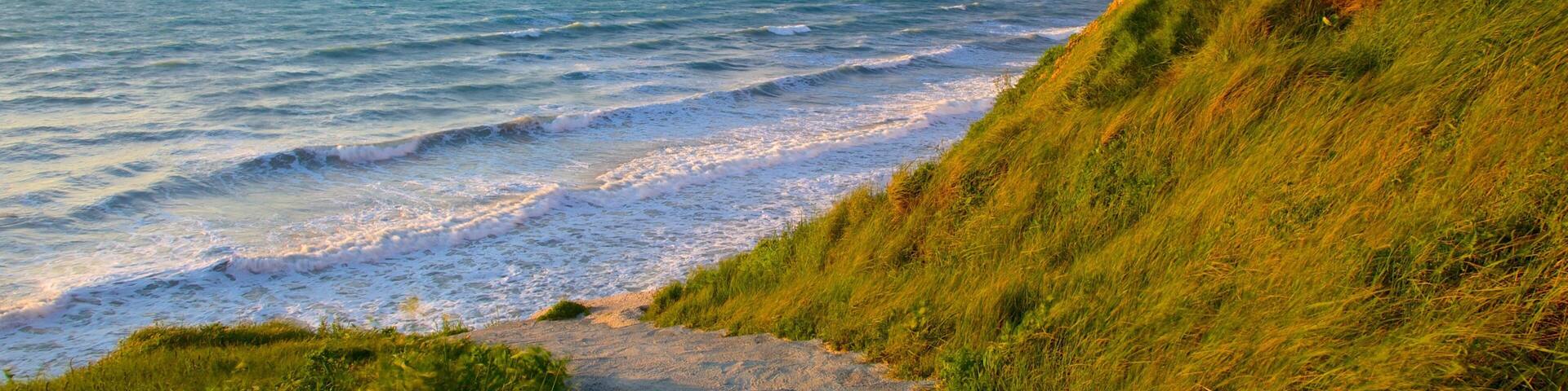 Sunset Beach ofreciendo vistas panorámicas, vistas de una costa y un atardecer