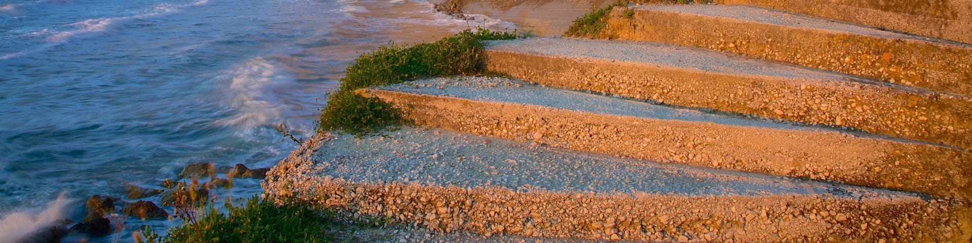 Logas Beach showing a sunset and rocky coastline