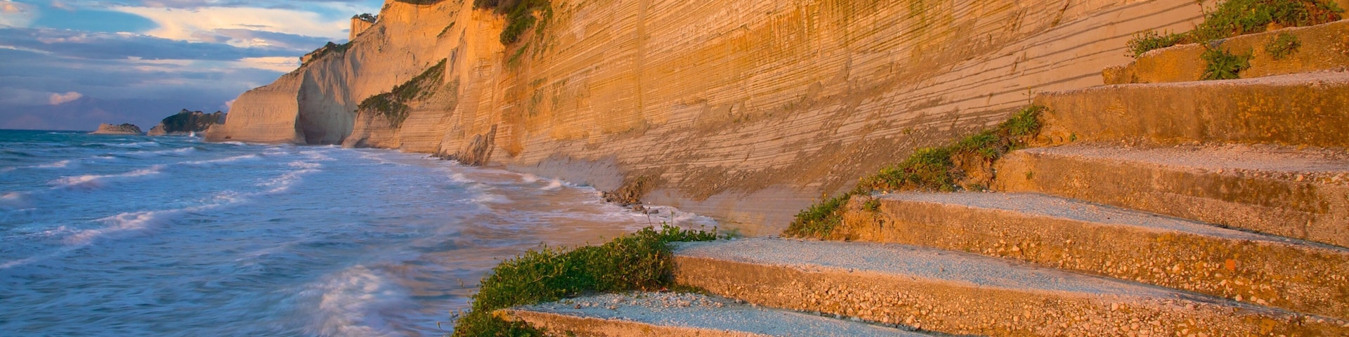 Logas Beach showing a sunset and rocky coastline