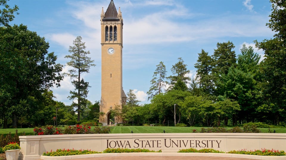 A clock tower at Iowa State University surrounded by lush greenery.