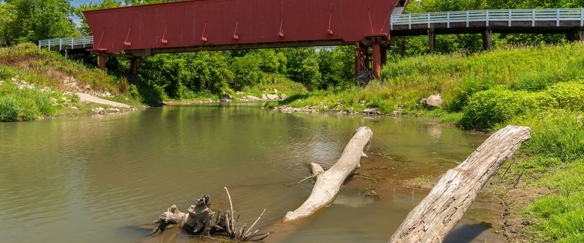 An Old Red Covered Bridge Over A River
