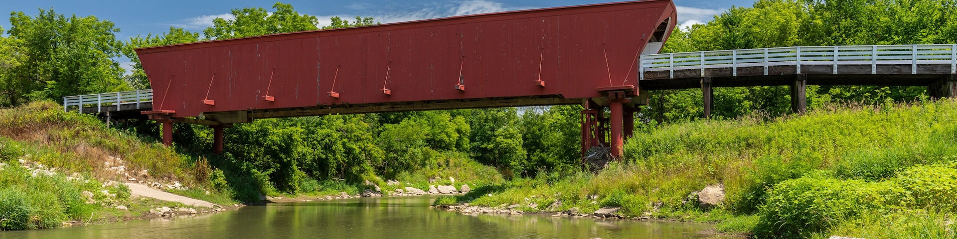 An Old Red Covered Bridge Over A River