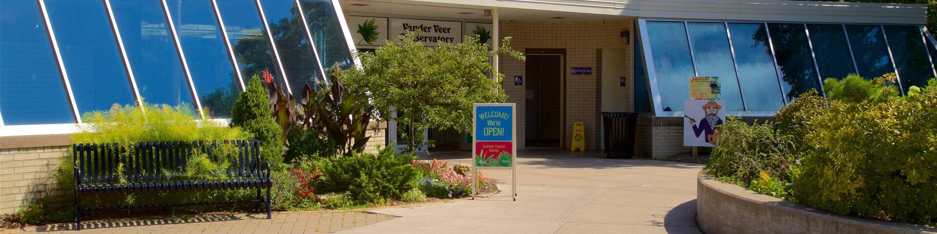 A building with large windows and a sign that reads "Vanderveer Conservatory."