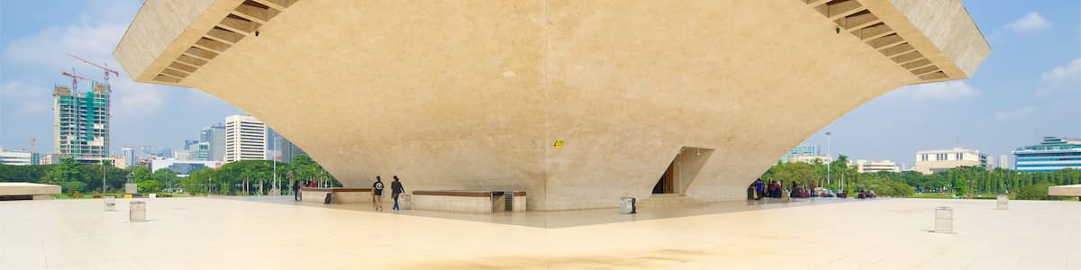 A large, triangular concrete structure with a flat roof and multiple ventilation slots.