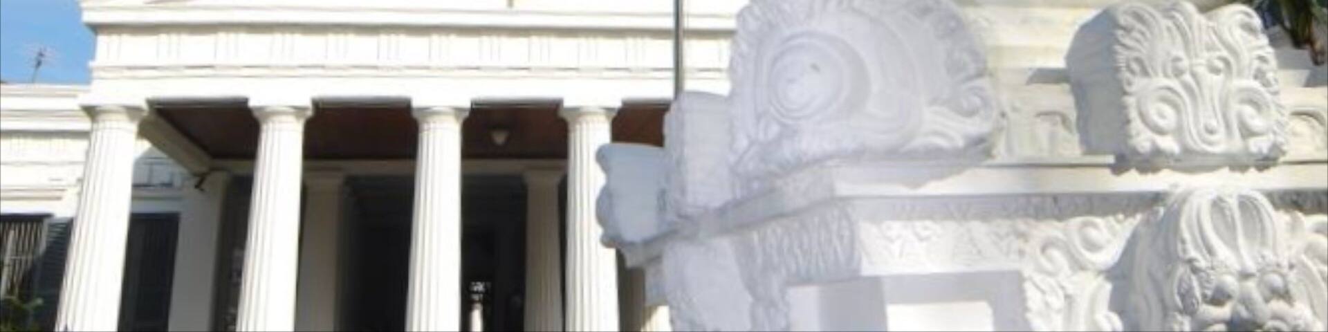 A museum with a statue of an elephant in front.