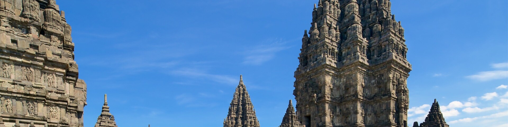 Prambanan Temple showing heritage architecture and a square or plaza as well as a small group of people
