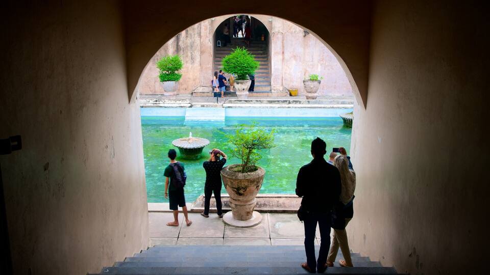 Water Castle which includes a pool and heritage architecture as well as a small group of people