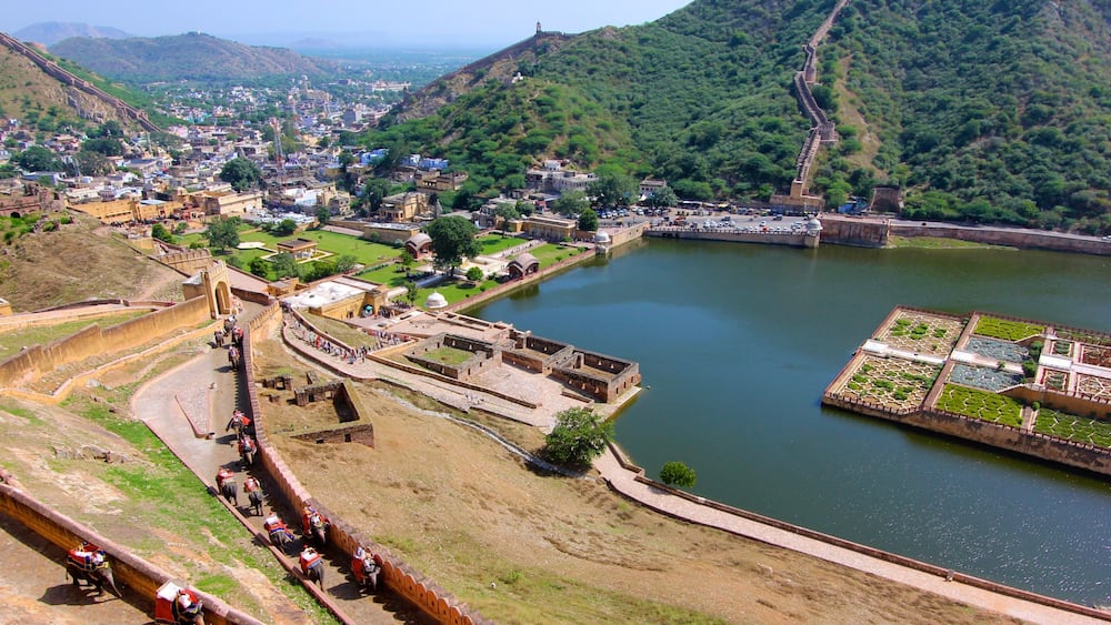 Amber Fort which includes a lake or waterhole, a city and landscape views