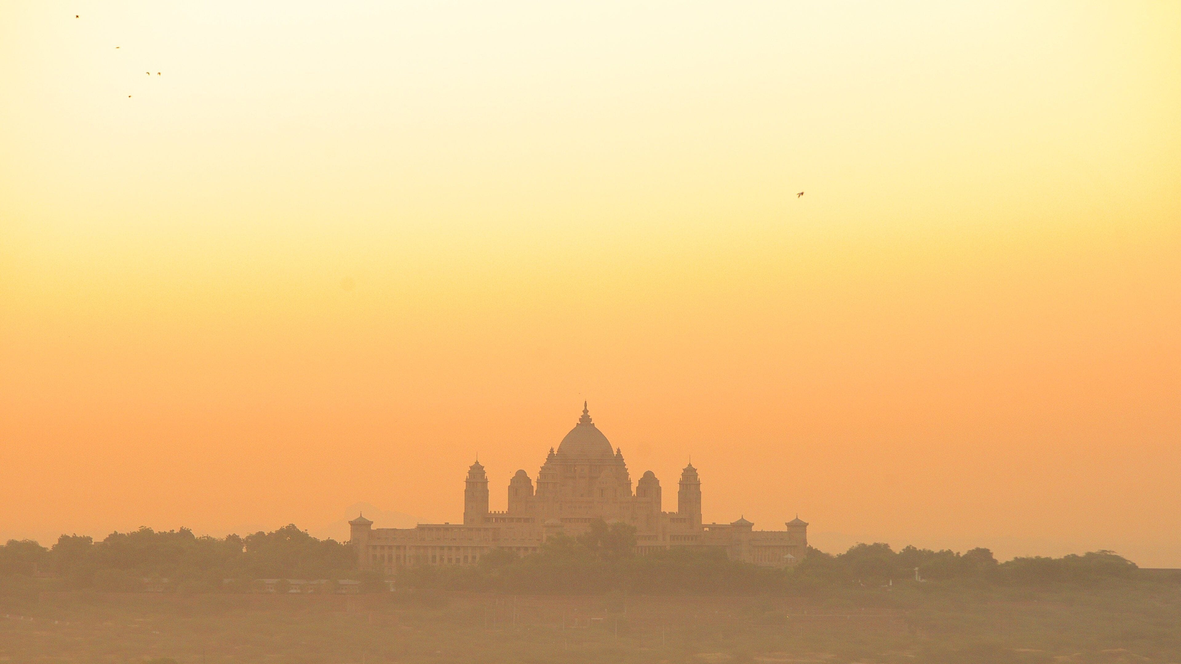 Umaid Bhawan Palace showing a sunset and chateau or palace