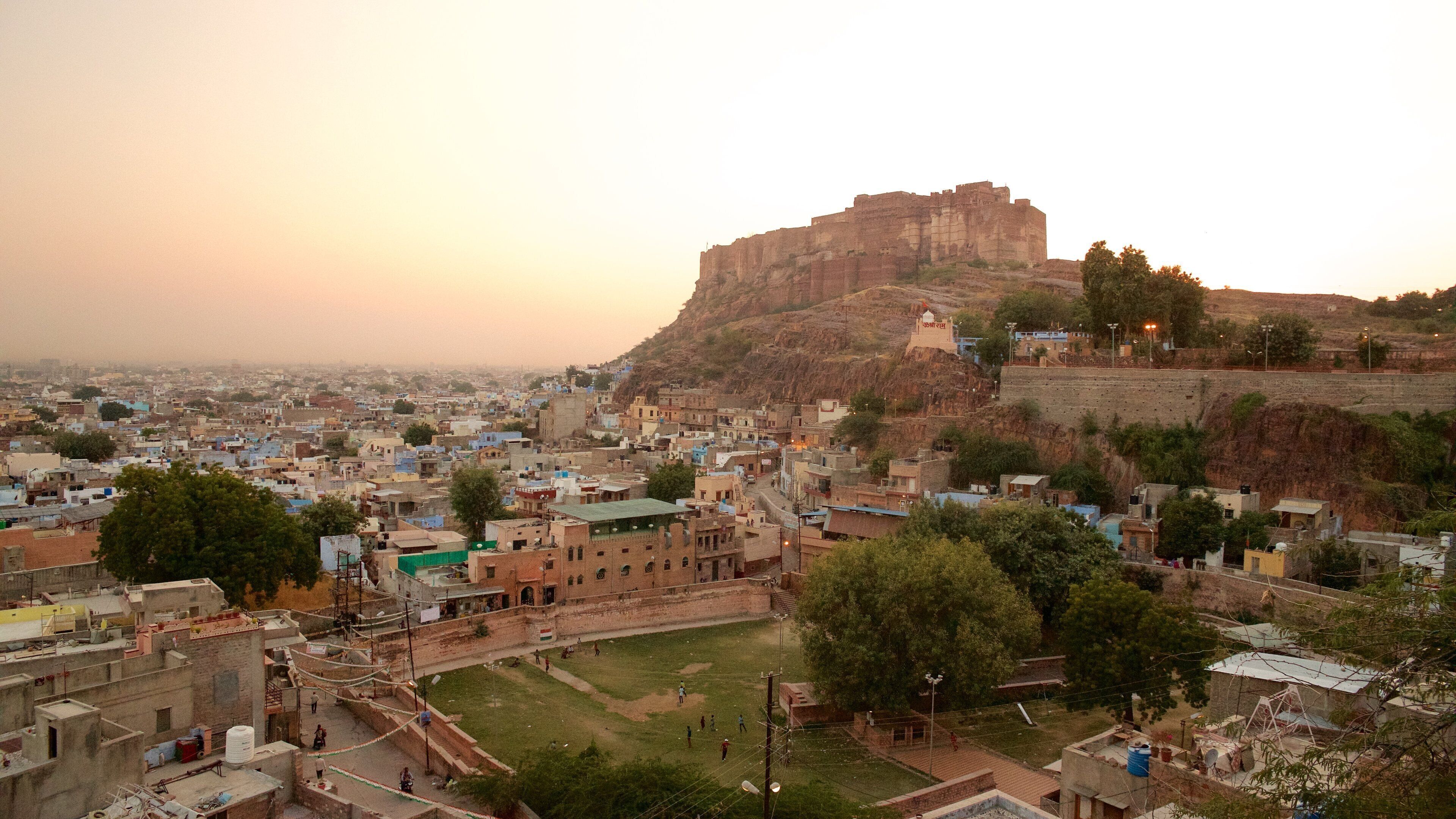Mehrangarh Fort which includes a city and a sunset