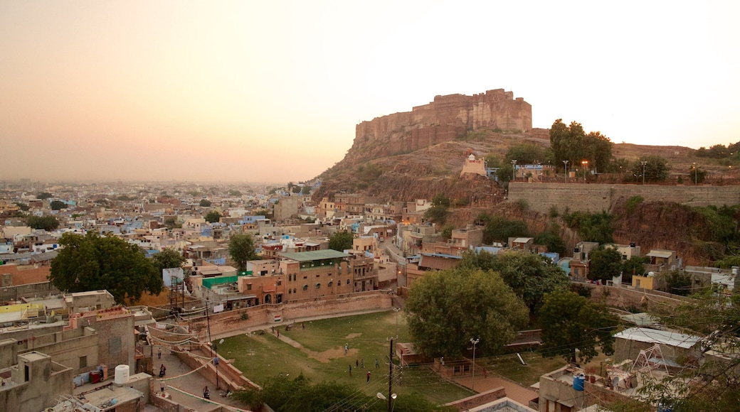 Mehrangarh Fort which includes a city and a sunset