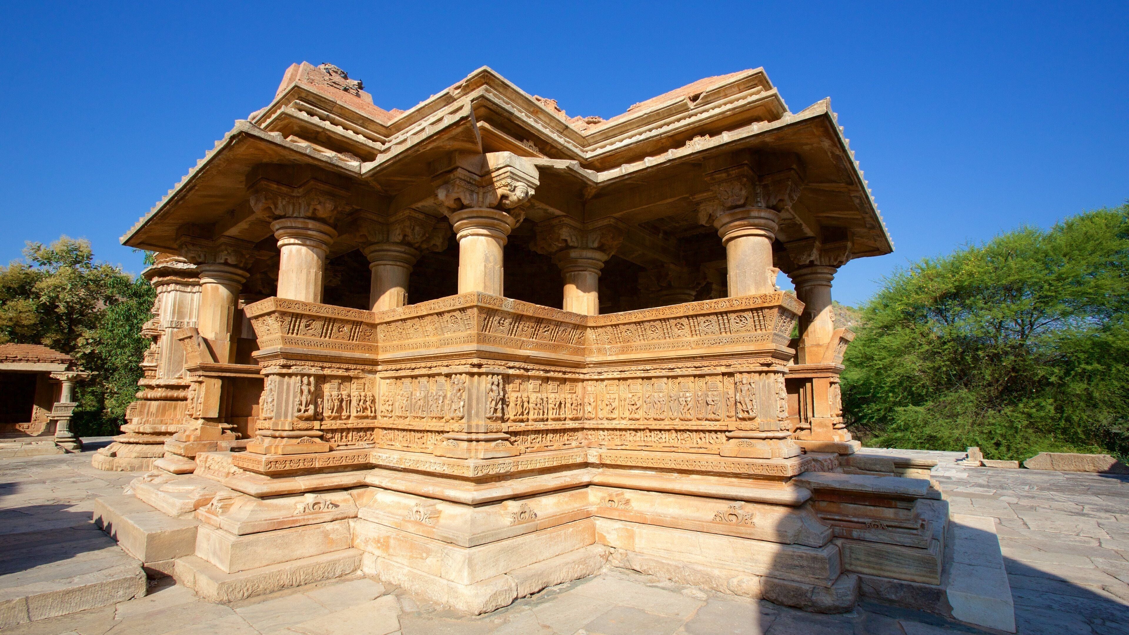 A detailed stone structure with intricate carvings and multiple columns.