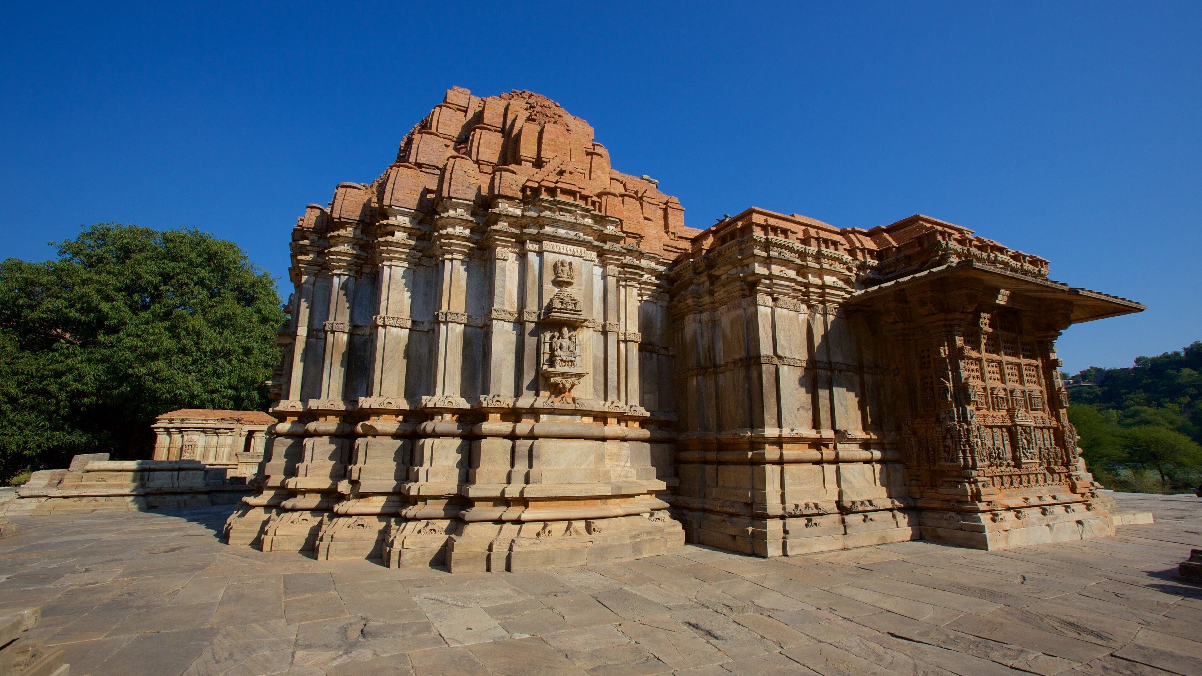 A large, intricately carved temple with a prominent central tower and detailed stonework.