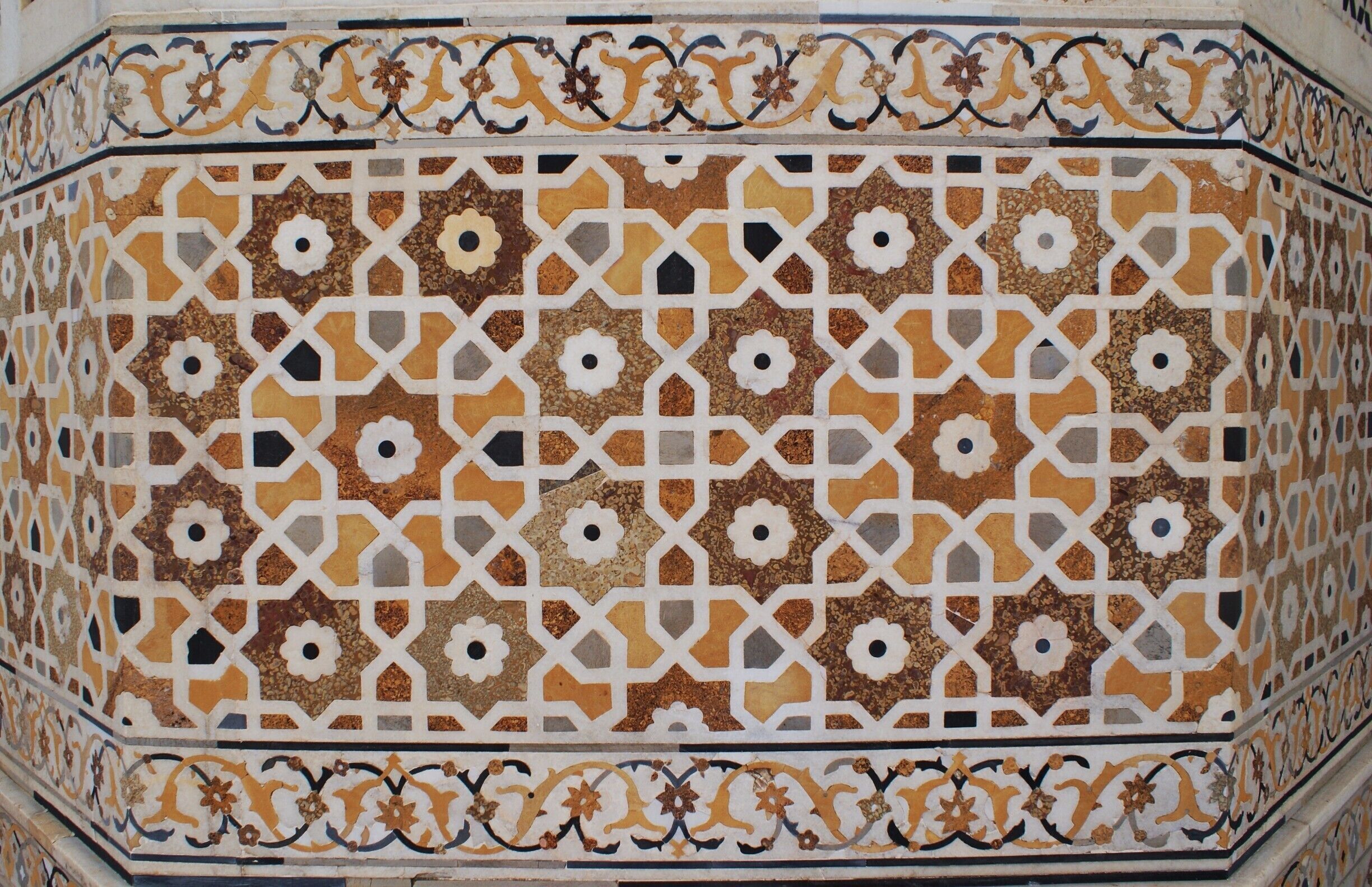 So many of India's Palaces and forts are covered in intricate stone work such as this wall found at the "Baby Taj" in Agra, India. Each color is a different stone, implanted within the white marble wall. #Patterns