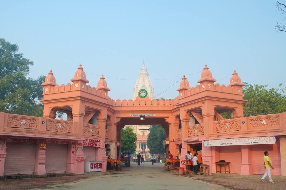 A temple entrance with intricate architecture and a clock tower.
