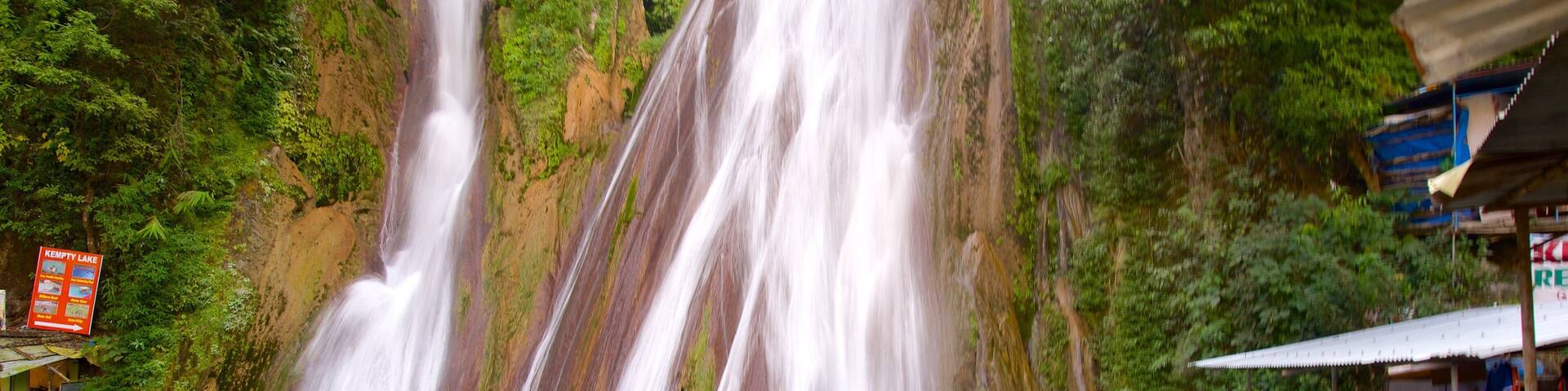 Kempty Falls featuring swimming and a waterfall as well as a small group of people