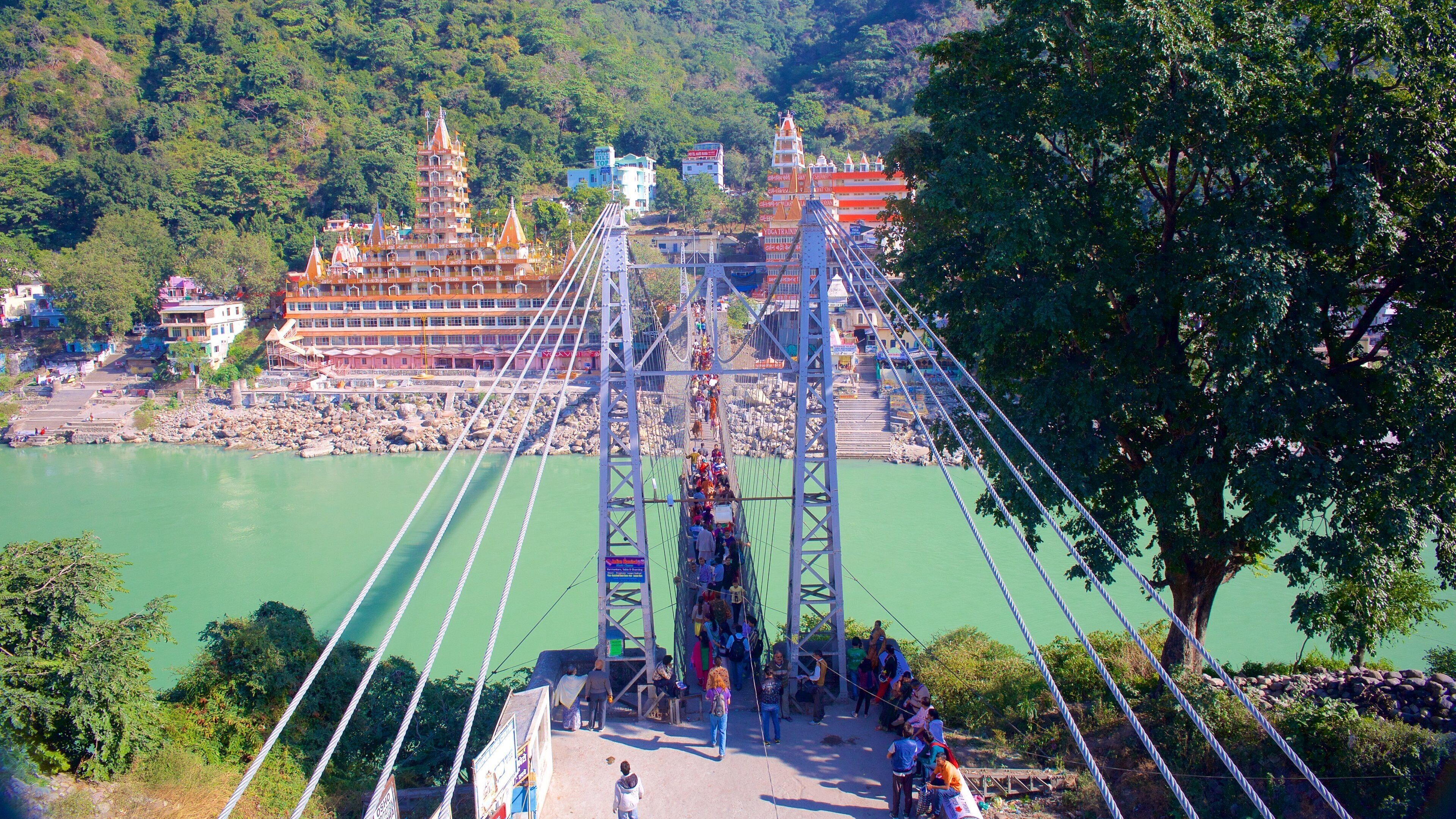 Lakshman Jhula showing a river or creek, a small town or village and a suspension bridge or treetop walkway