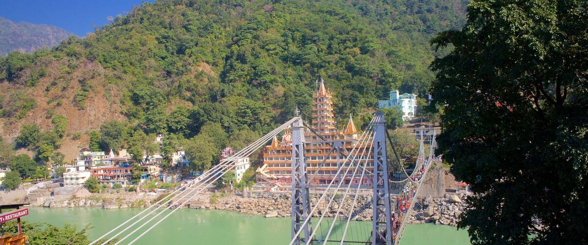 Lakshman Jhula which includes a small town or village, a river or creek and a suspension bridge or treetop walkway