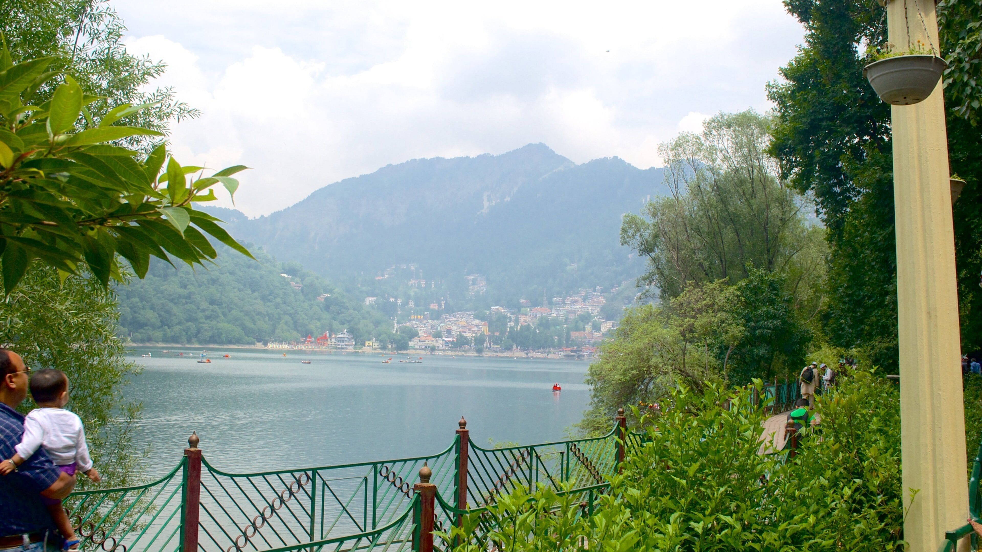 Nainital Lake featuring a lake or waterhole and mountains