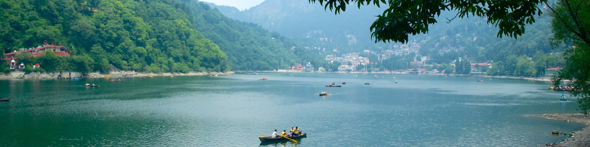 Nainital Lake showing kayaking or canoeing and a lake or waterhole as well as a small group of people