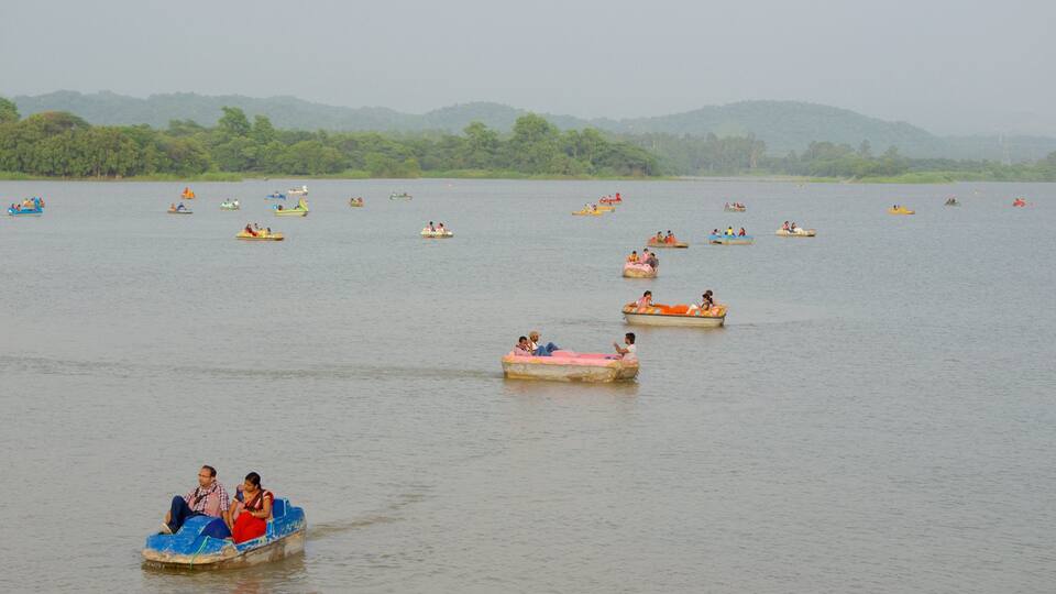 A calm lake with numerous small boats scattered across the water.