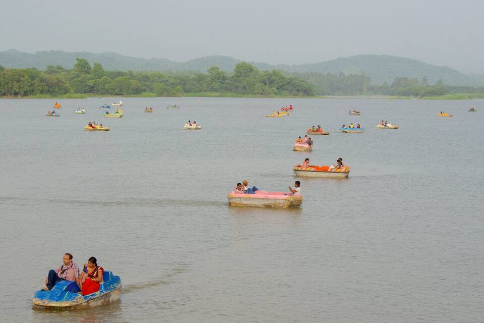 A calm lake with numerous small boats scattered across the water.