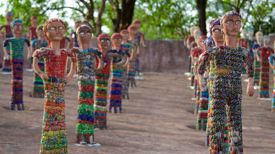 A row of colorful, beaded sculptures of people.