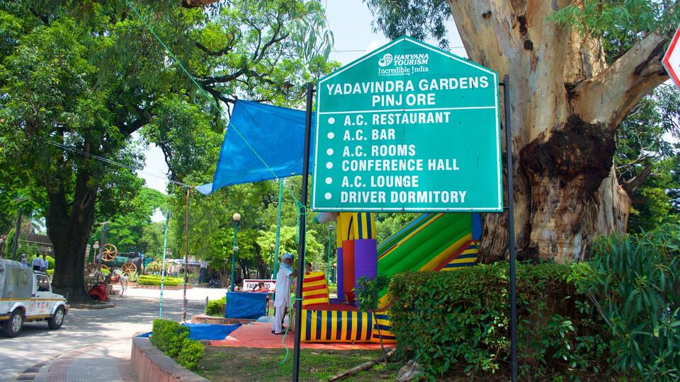 A sign for Yadavindra Gardens Pinjore listing amenities like A.C. Restaurant, A.C. Bar, A.C. Rooms, Conference Hall, A.C. Lounge, and Driver Dormitory.
