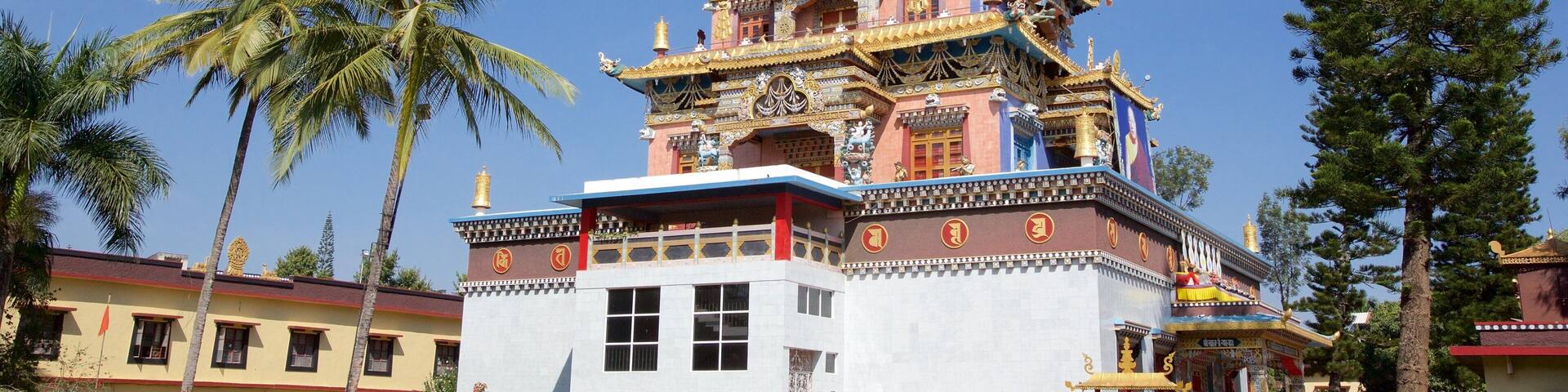 A multi-tiered temple with ornate golden decorations and a large bell tower.