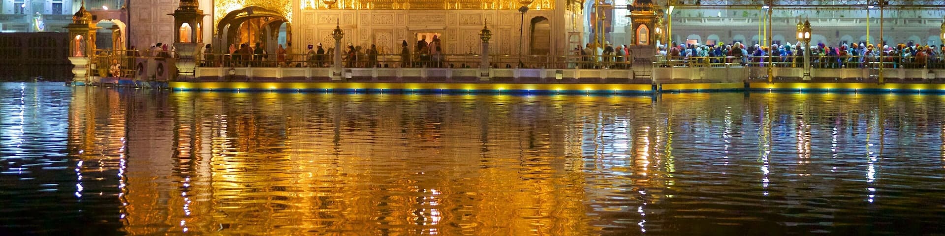 Golden Temple which includes night scenes, heritage elements and a lake or waterhole