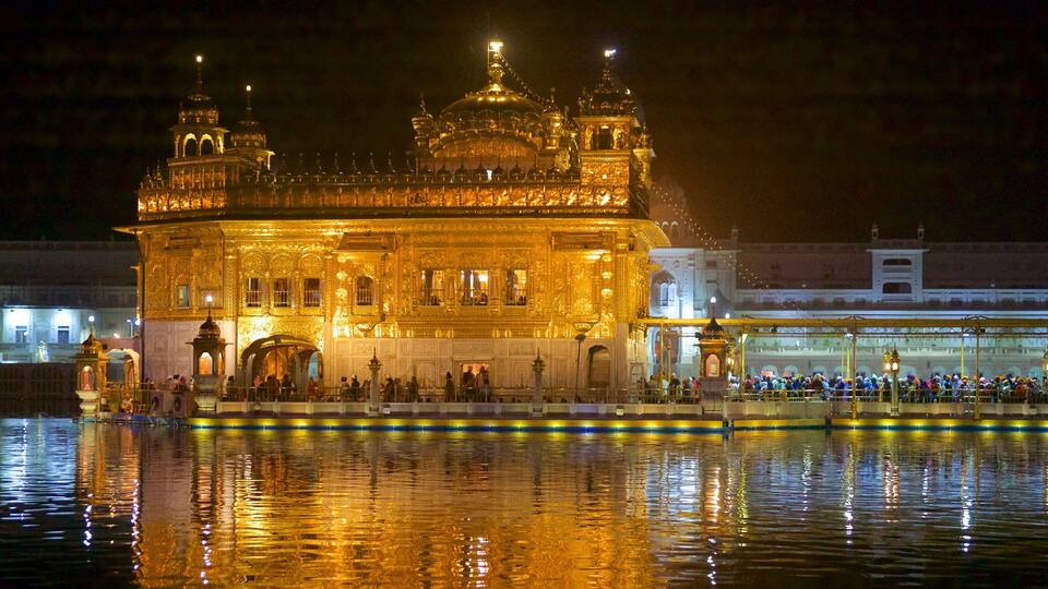 Golden Temple which includes night scenes, heritage elements and a lake or waterhole