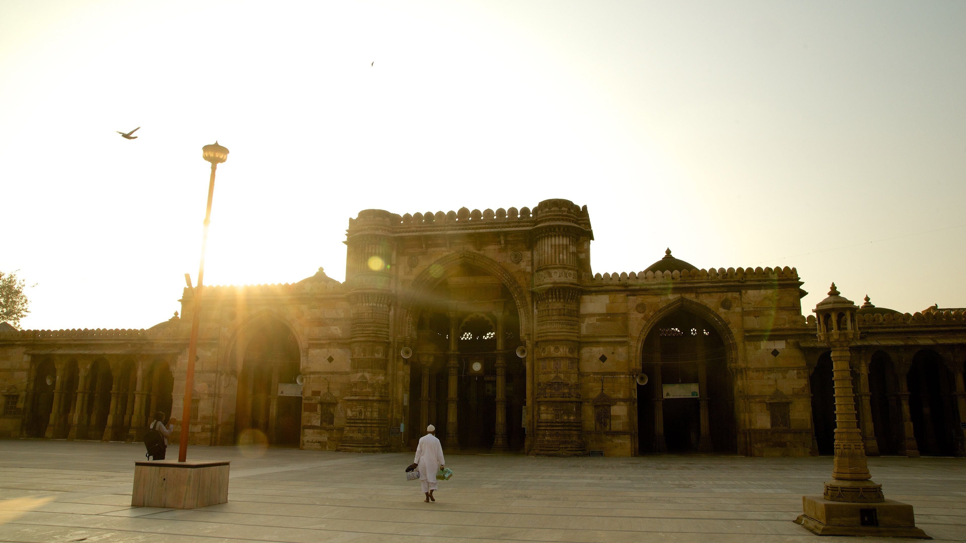 Jama Masjid Mosque which includes heritage architecture and a sunset