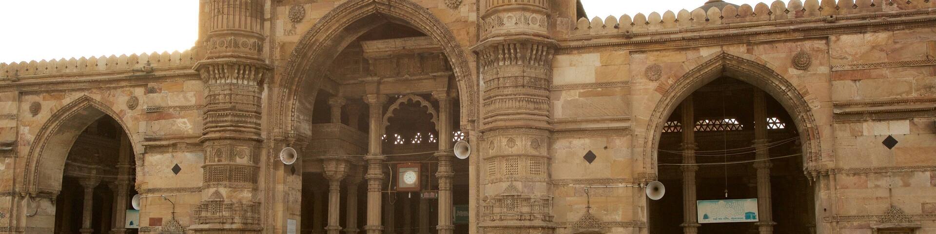 A historic building with intricate carvings and arches.